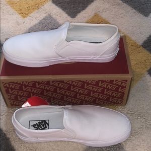 White slip-on vans, van sticker, and box.
